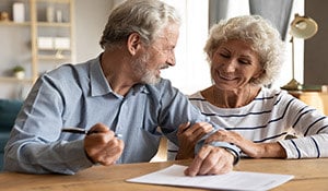 couple signing will and trust documents