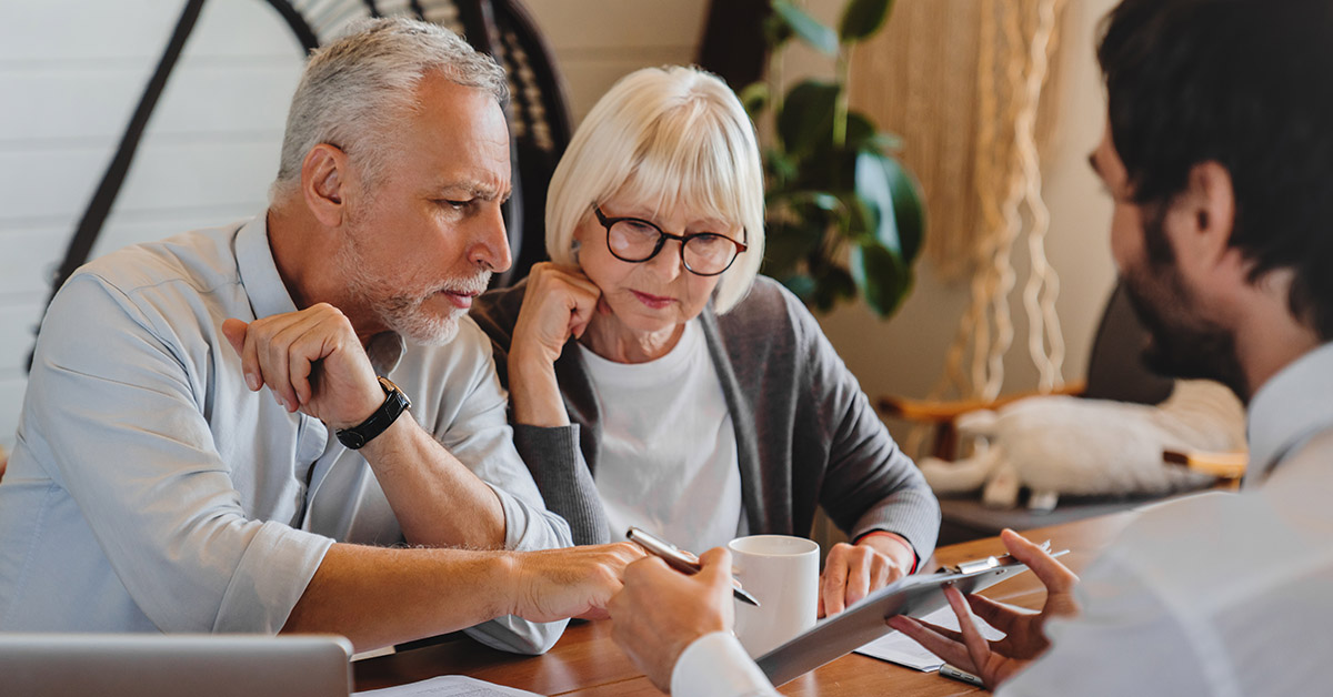 retired couple meeting with adviser